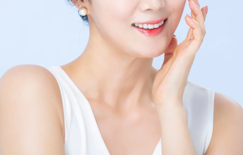 Middle aged woman smiling after Korean facelift.