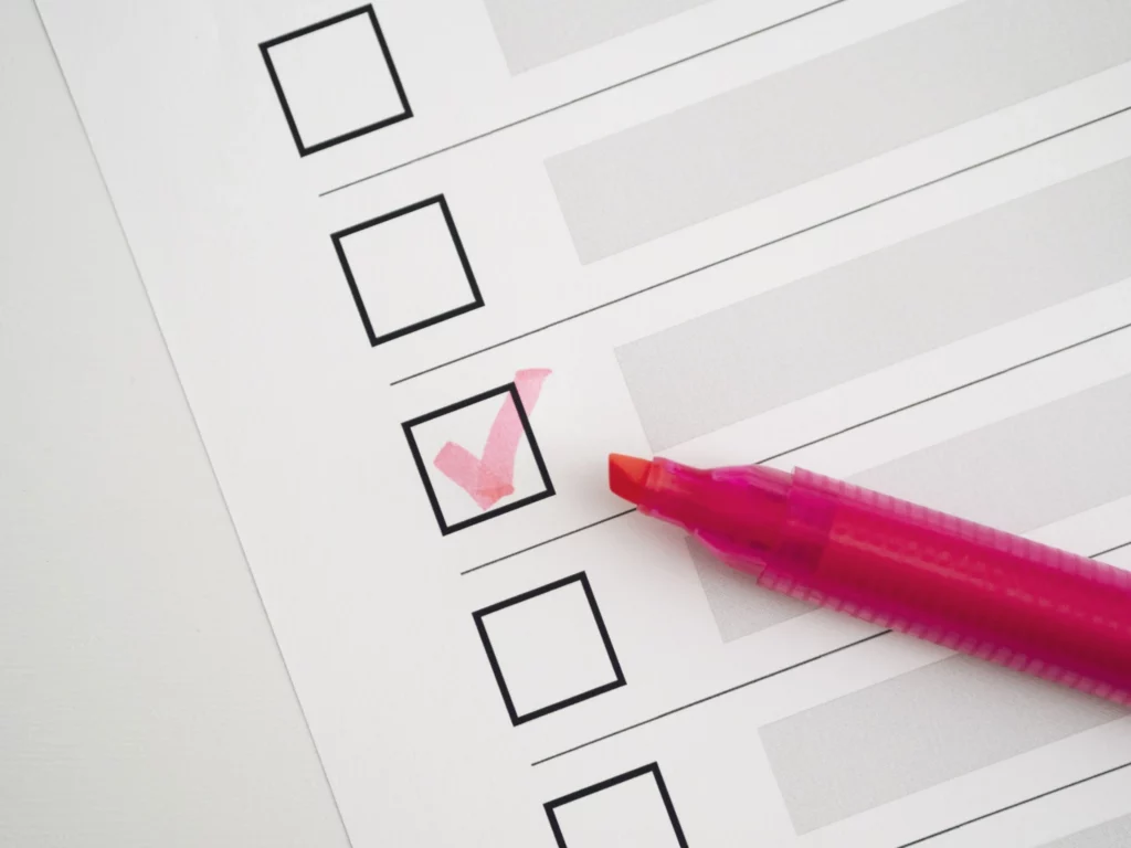 Double chin surgery preparation checklist marked with a pen, representing preoperative planning and readiness before double chin surgery.