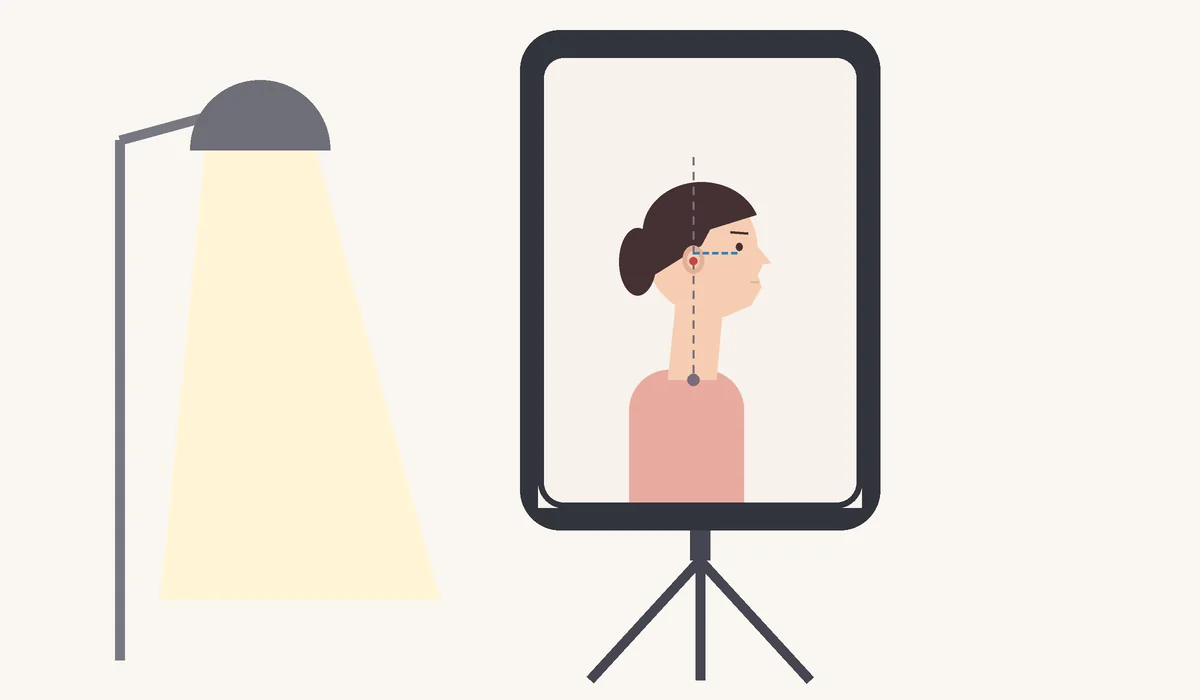 Checking double chin exercises progress: a phone on a tripod frames a side profile with the eye corner and ear level, lit by the same lamp