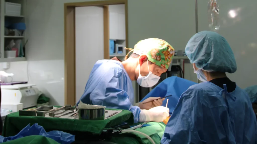 Surgeons operating in a Mine Plastic Surgery operating room, the setting for endoscopic breast augmentation