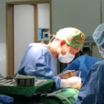 Surgeons operating in a Mine Plastic Surgery operating room, the setting for endoscopic breast augmentation